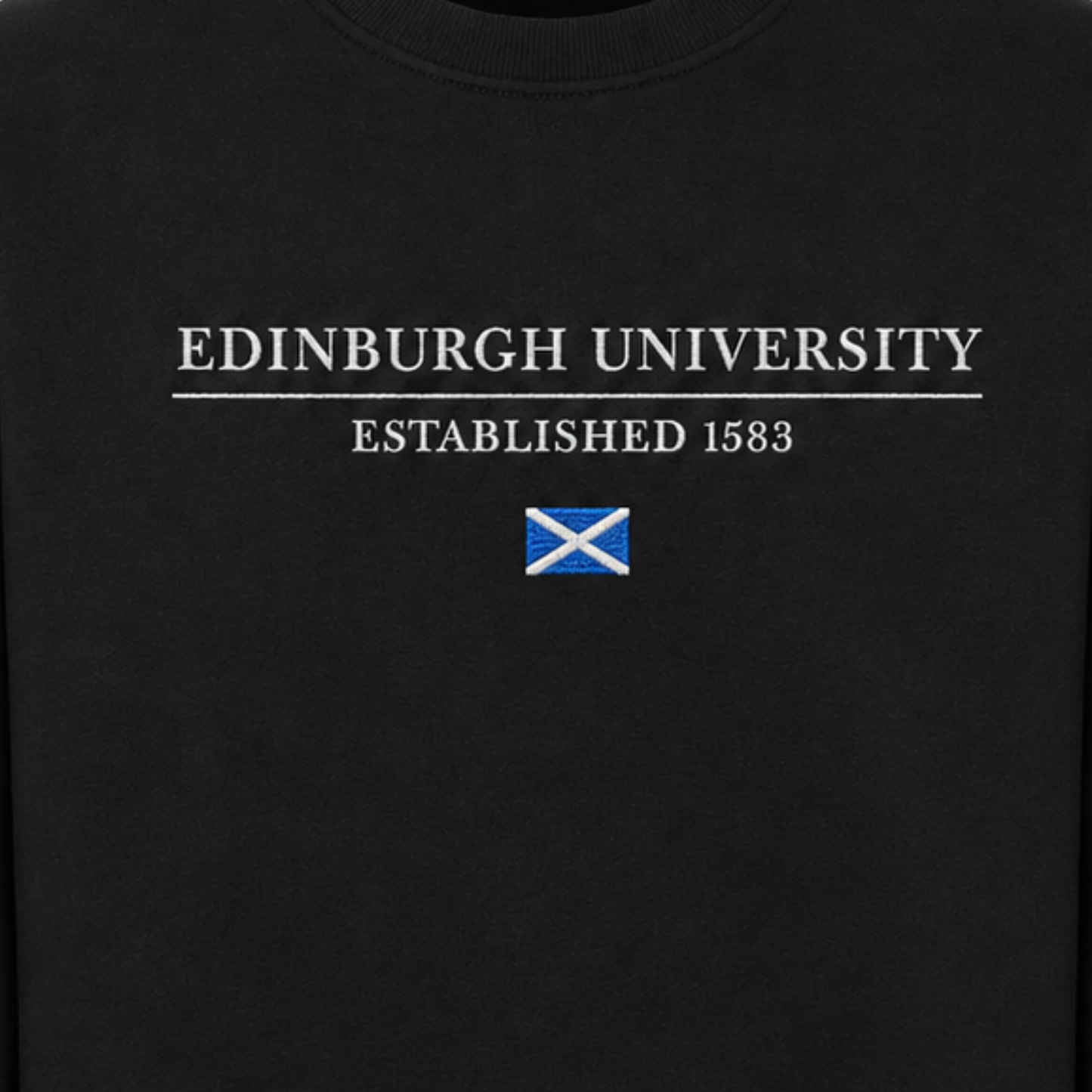 Close up of 'EDINBURGH UNIVERSITY ESTABLISHED 1583' embroidery above embroidered Saltire Flag.