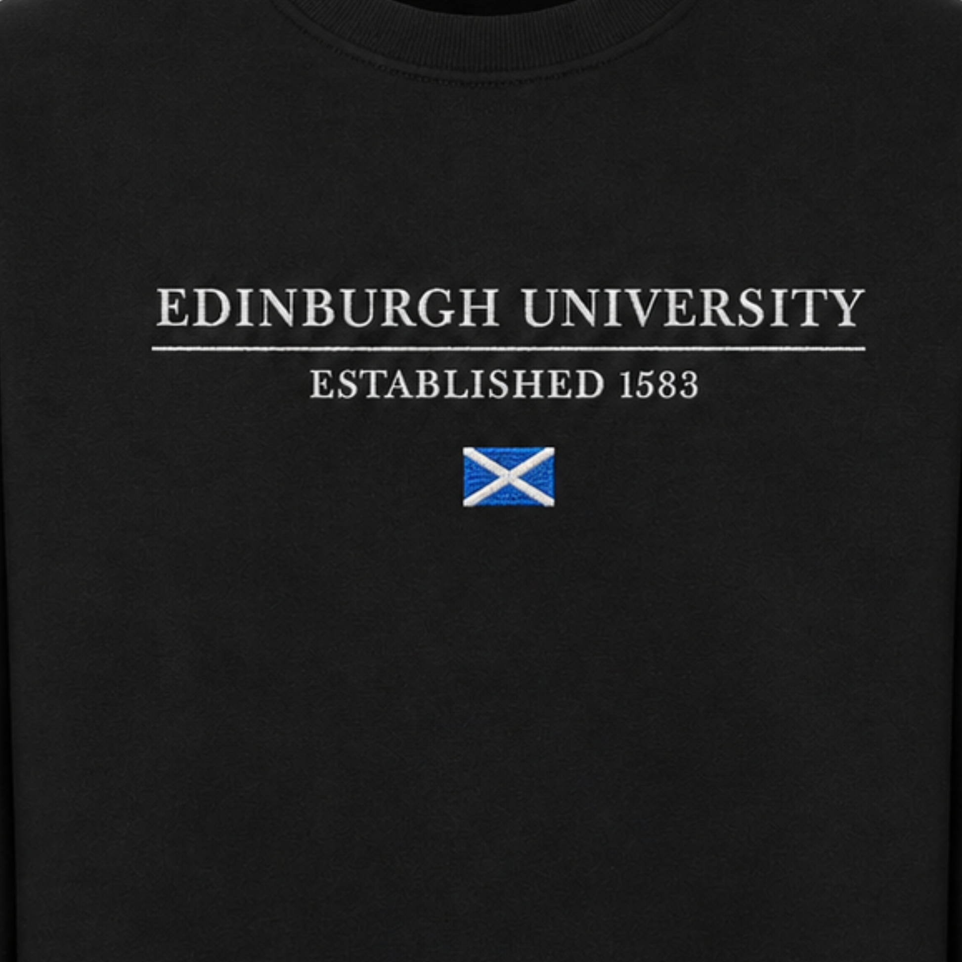 Close up of 'EDINBURGH UNIVERSITY ESTABLISHED 1583' embroidery above embroidered Saltire Flag.