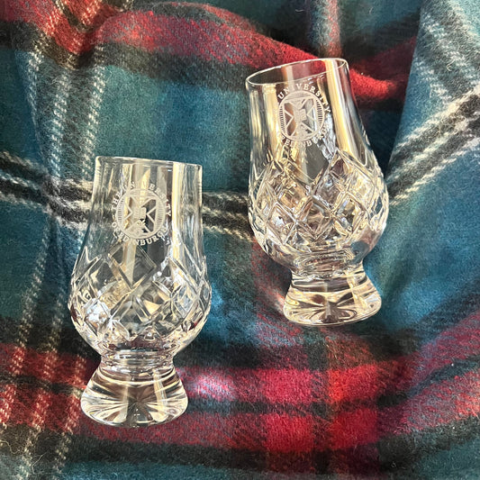 A set of two handmade and hand-cut crystal pear-shaped whisky glasses with the University crest engraved.