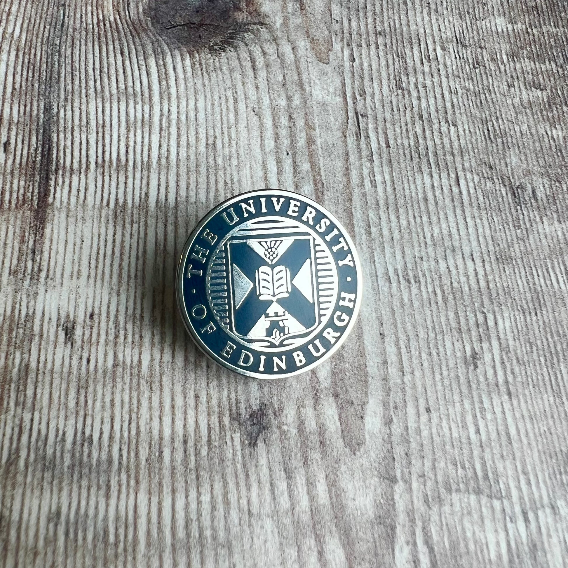 Navy and Silver Crest pin badge