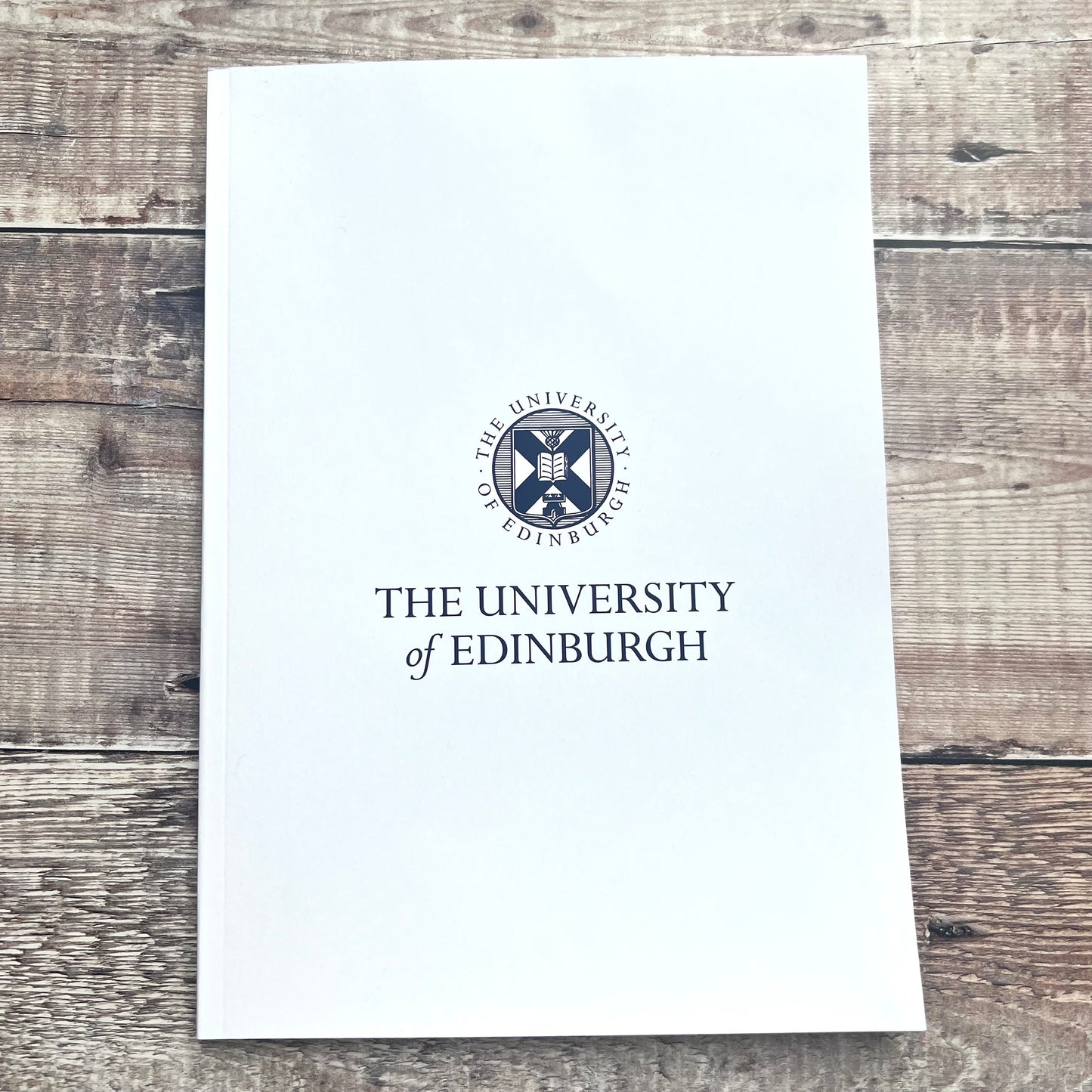 White a4 notebook cover featuring University crest and name in navy