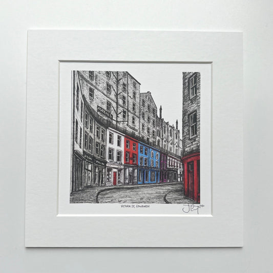 mounted print of Victoria Street, mostly black and white with some red and blue buildings