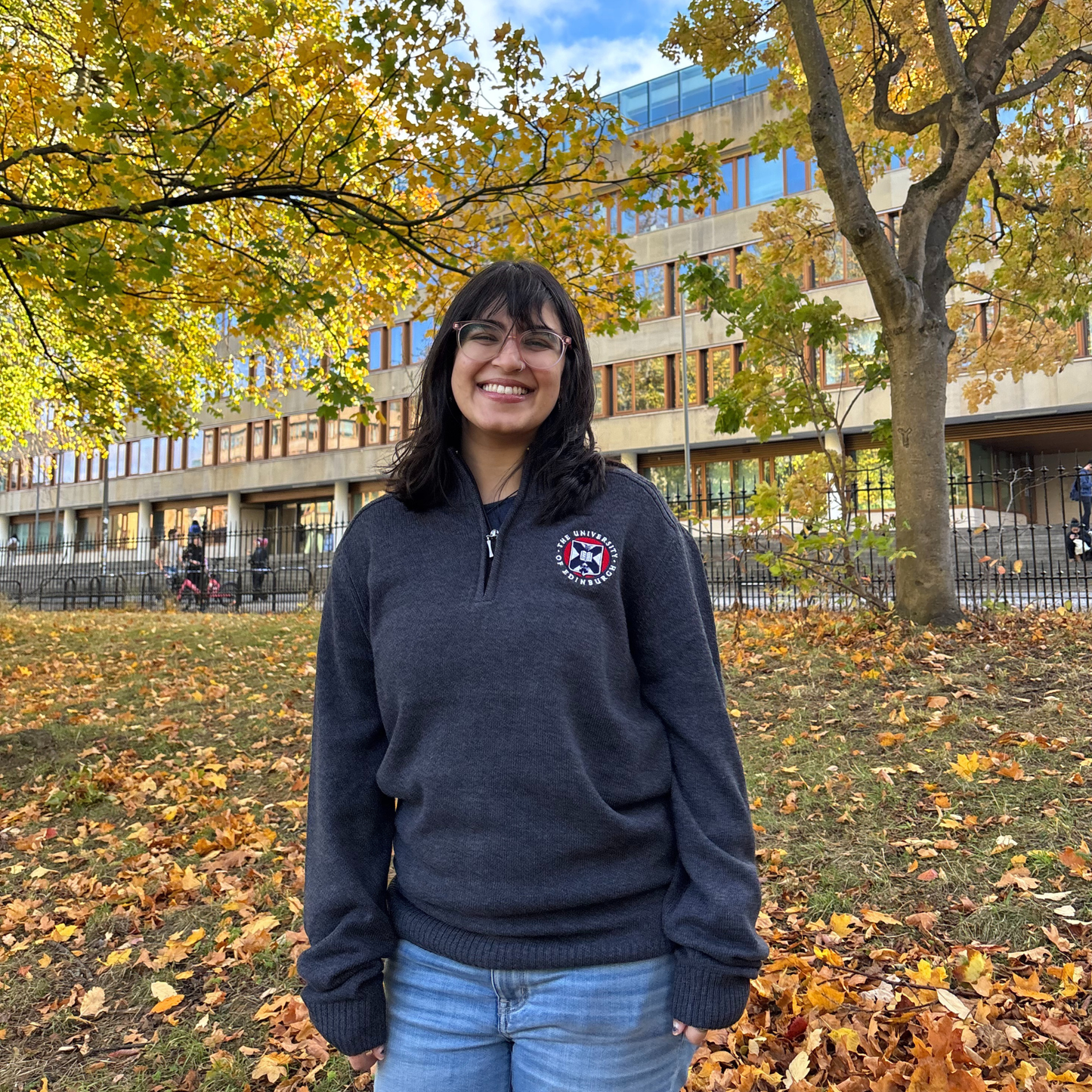 Model wears our Knit Quarter Zip in colour charcoal in George Square Gardens.