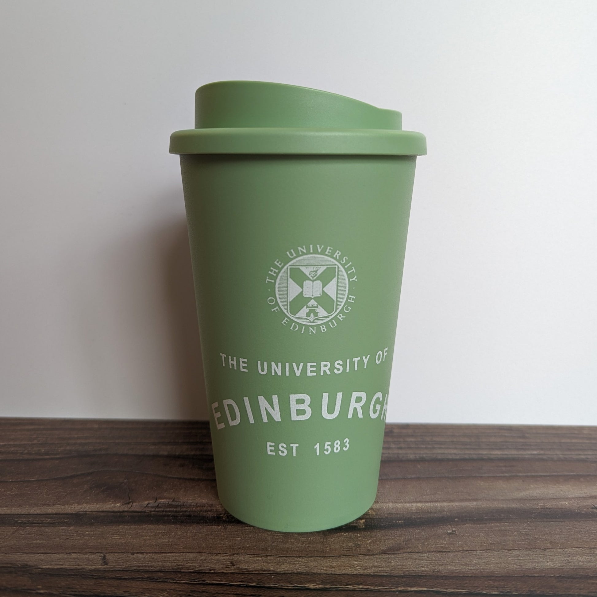 Eco Coffee Cup in Sage Green, with the design in White.