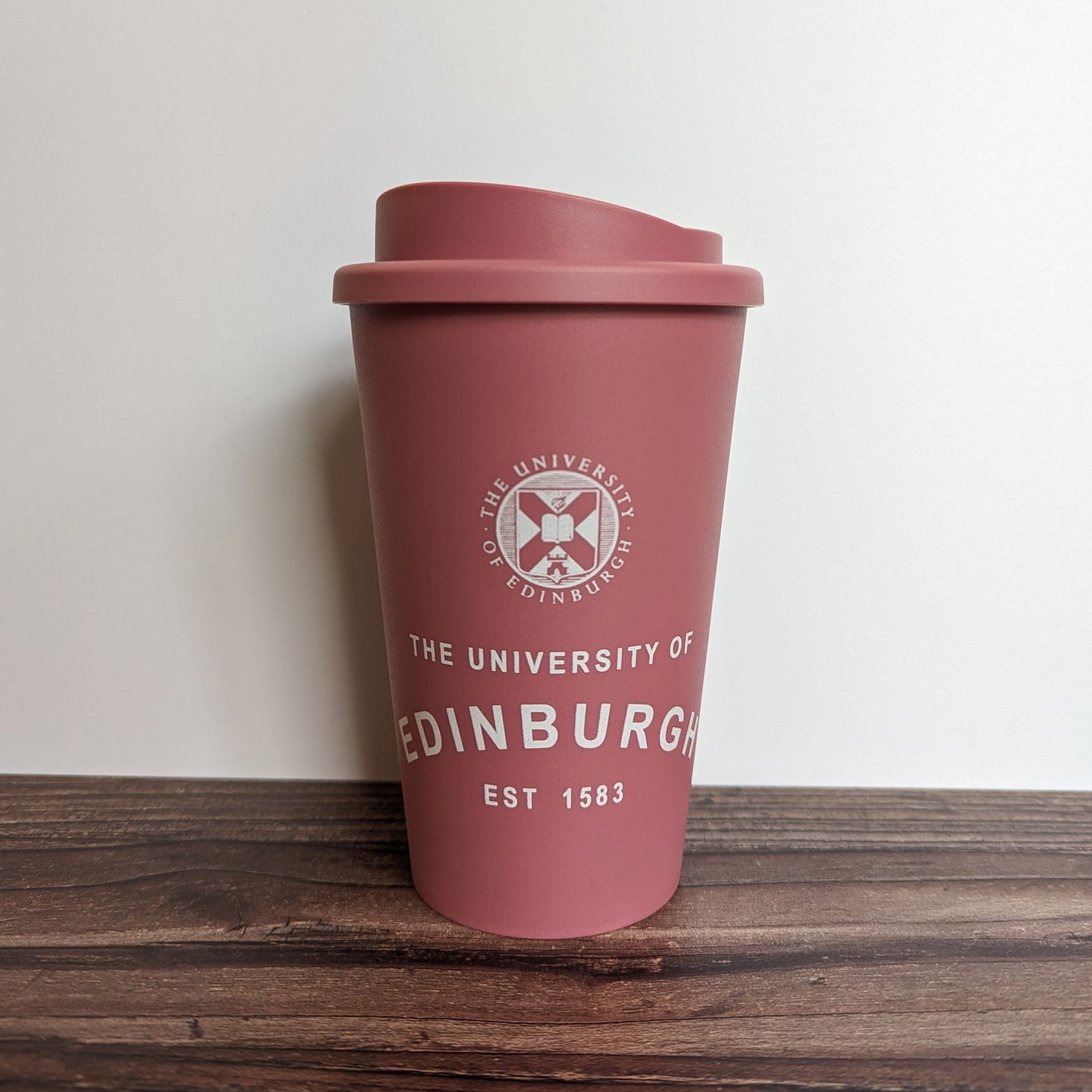 Eco Coffee Cup in Raspberry, with the design in White.