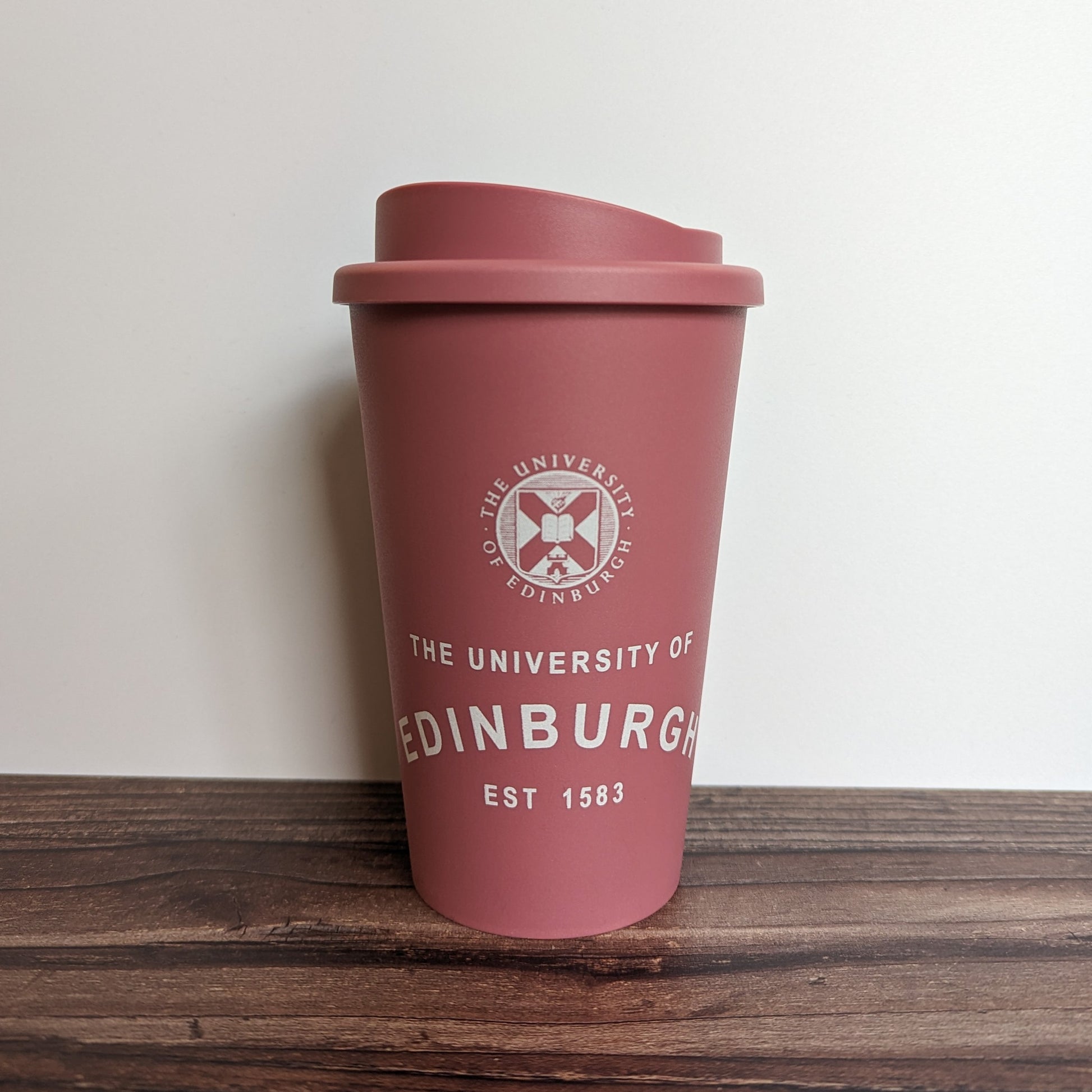 Eco Coffee Cup in Raspberry, with the design in White.