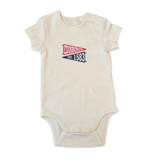 A cream coloured babygrow with a red pennant in the centre that says 'Edinburgh' and a navy pennant beneath it facing the opposite direction that says 'EST. 1583' in white text.