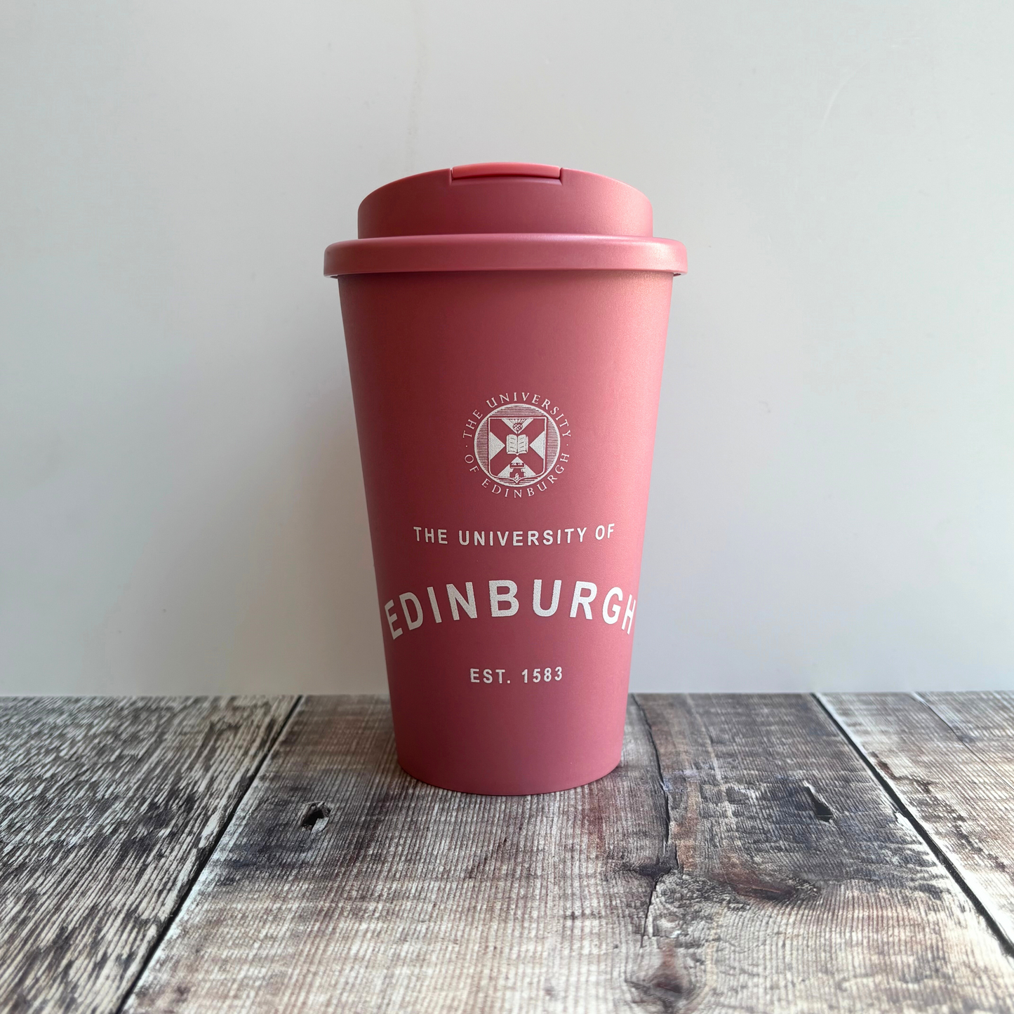 Eco Coffee Cup in pink with screw-on flip-lid and 350 ml capacity. Features the University crest and our established print in white. 