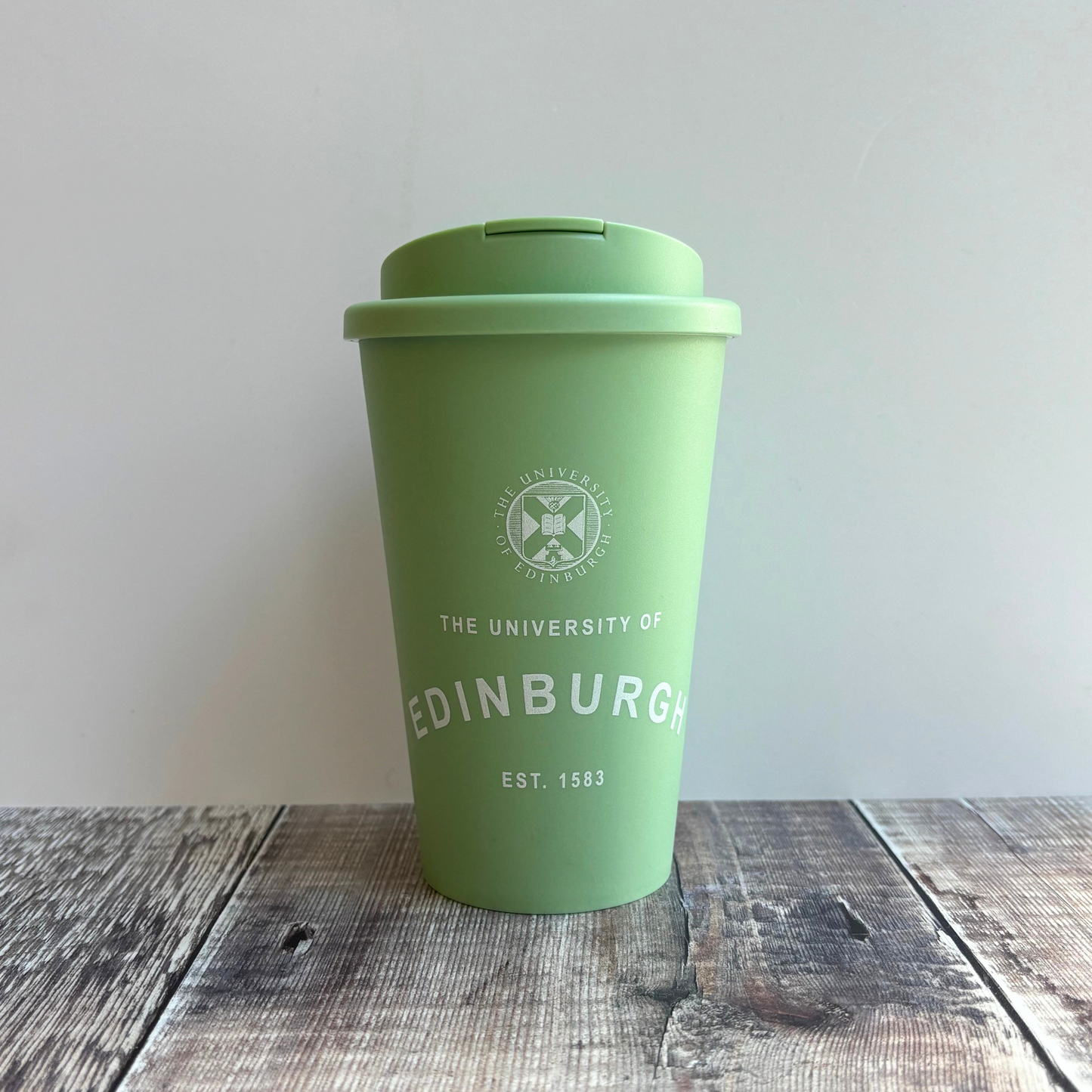 Eco Coffee Cup in sage green with screw-on flip-lid and 350 ml capacity. Features the University crest and our established print in white. 