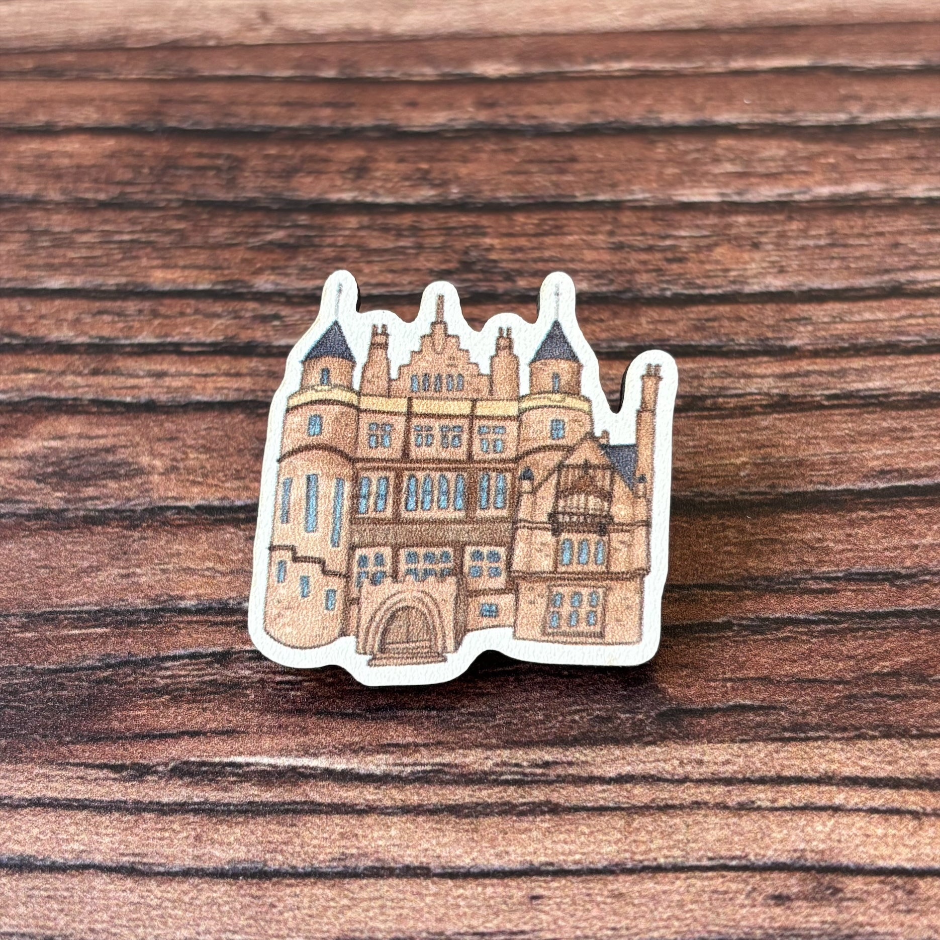 The Teviot Row House wooden pin badge.