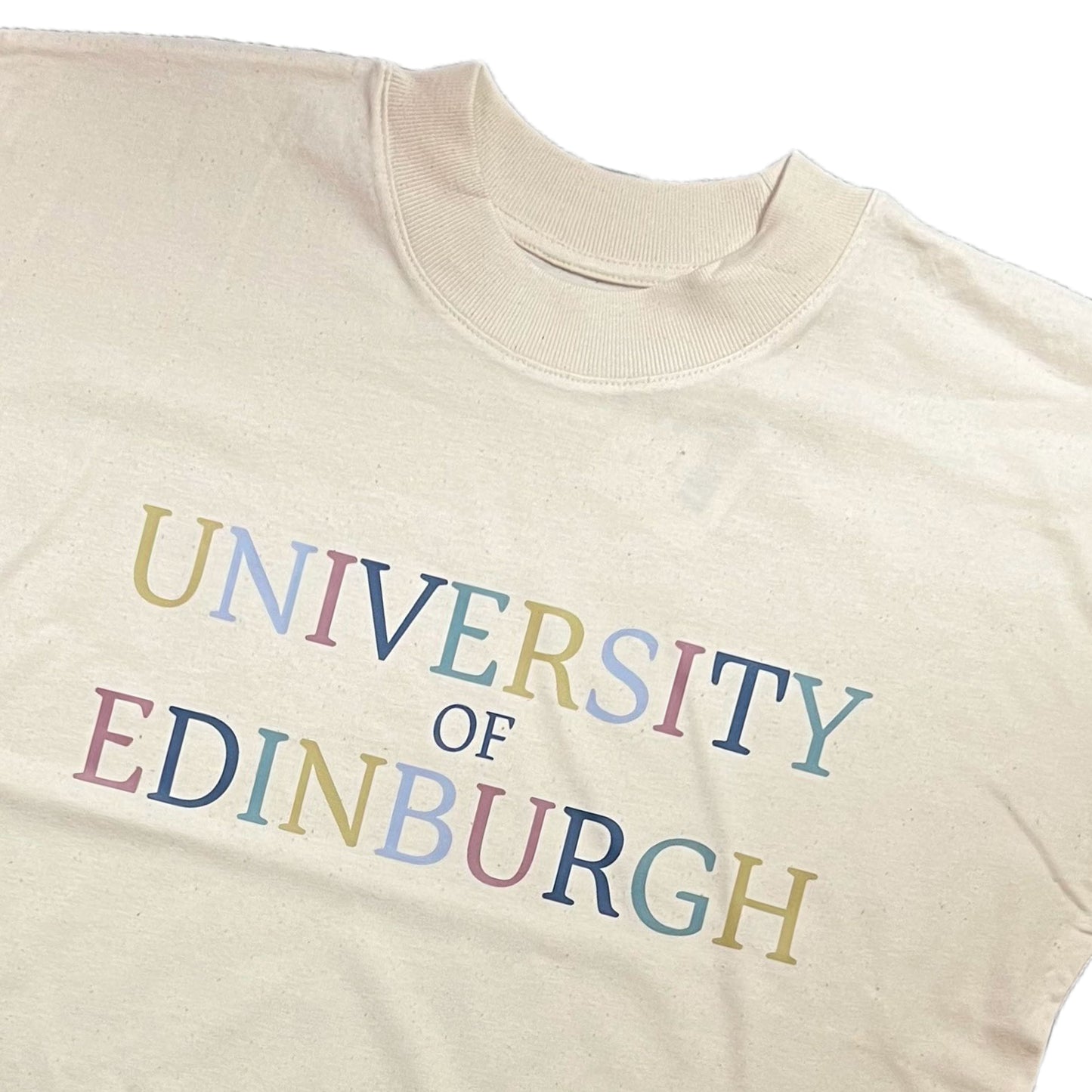 Close-up of colour text on oversized T-shirt.