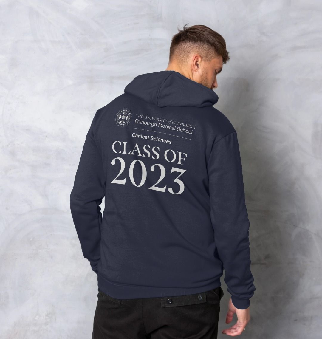 Model wears Navy Clinical Sciences 'Class Of' Graduate Hoodie showing back design.