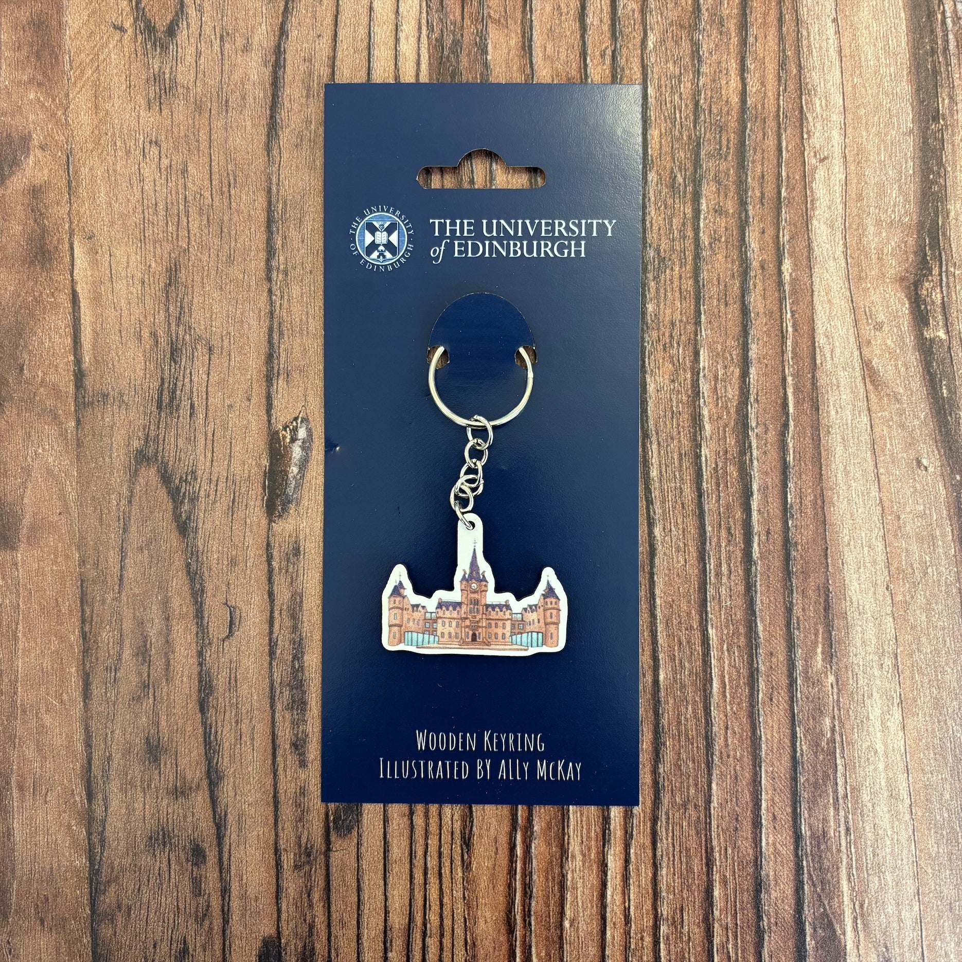 The Edinburgh futures Institute wooden keyring on its backing card.