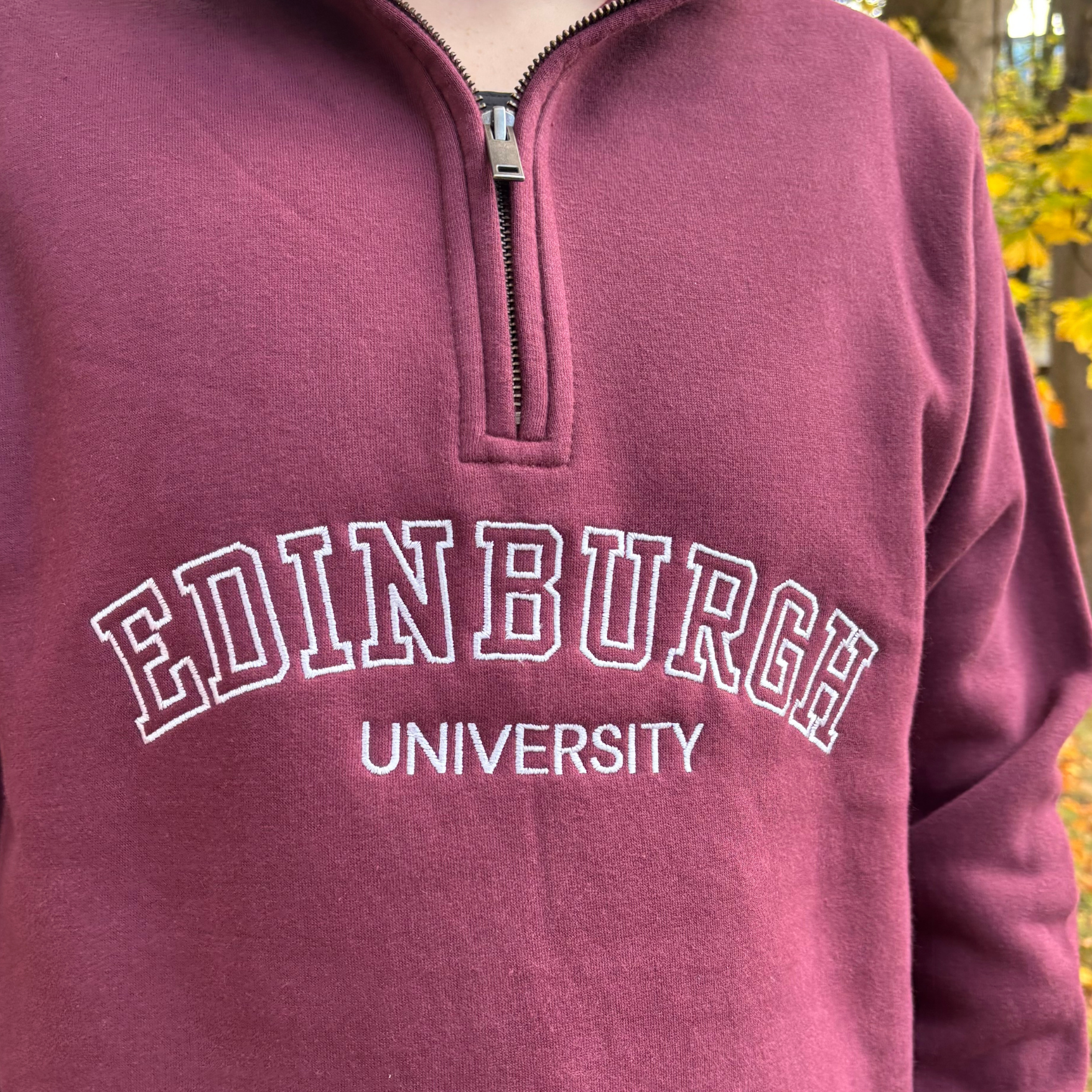White embroidery detail on the varsity quarterip zip sweatshirt.