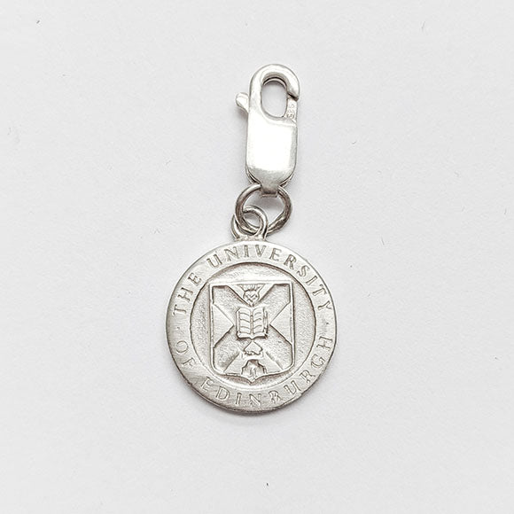 Silver charm of the University Crest with a claw clasp.