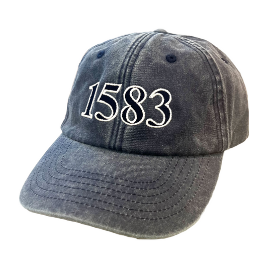 Side view of a dark blue denim baseball cap with large blue and white text reading '1583'