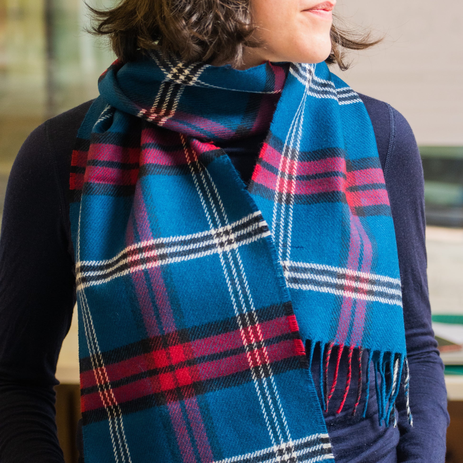 Our model wearing the tartan lambswool scarf around her neck.