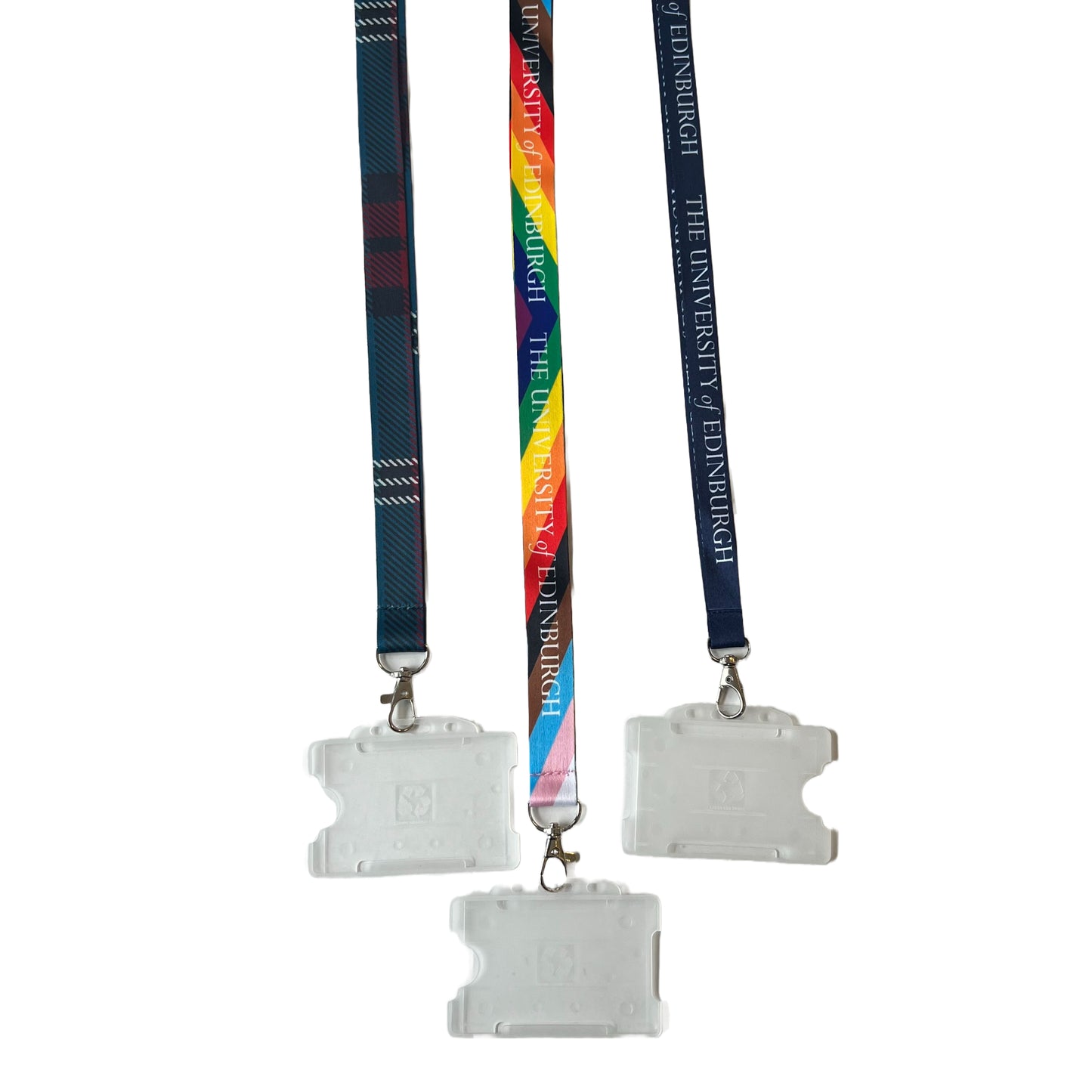 The navy blue lanyard is pictured on the right. In the middle our progress lanyard that says 'University of Edinburgh' in white text and a plastic cardholder. On the left is the University tartan lanyard with plastic cardholder.