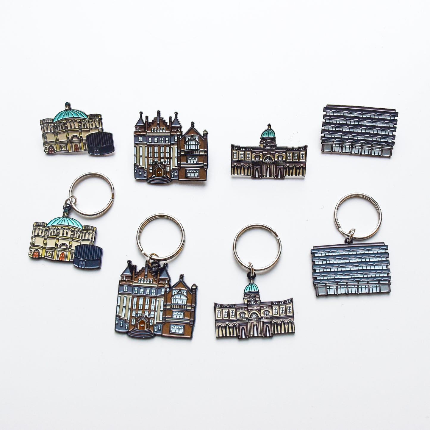 A selection of our Enamel Keyrings with their matching Enamel Pin counterparts. The deigns shown here are: Mc Ewan Hall, Teviot Row House, Old College and Main Library.