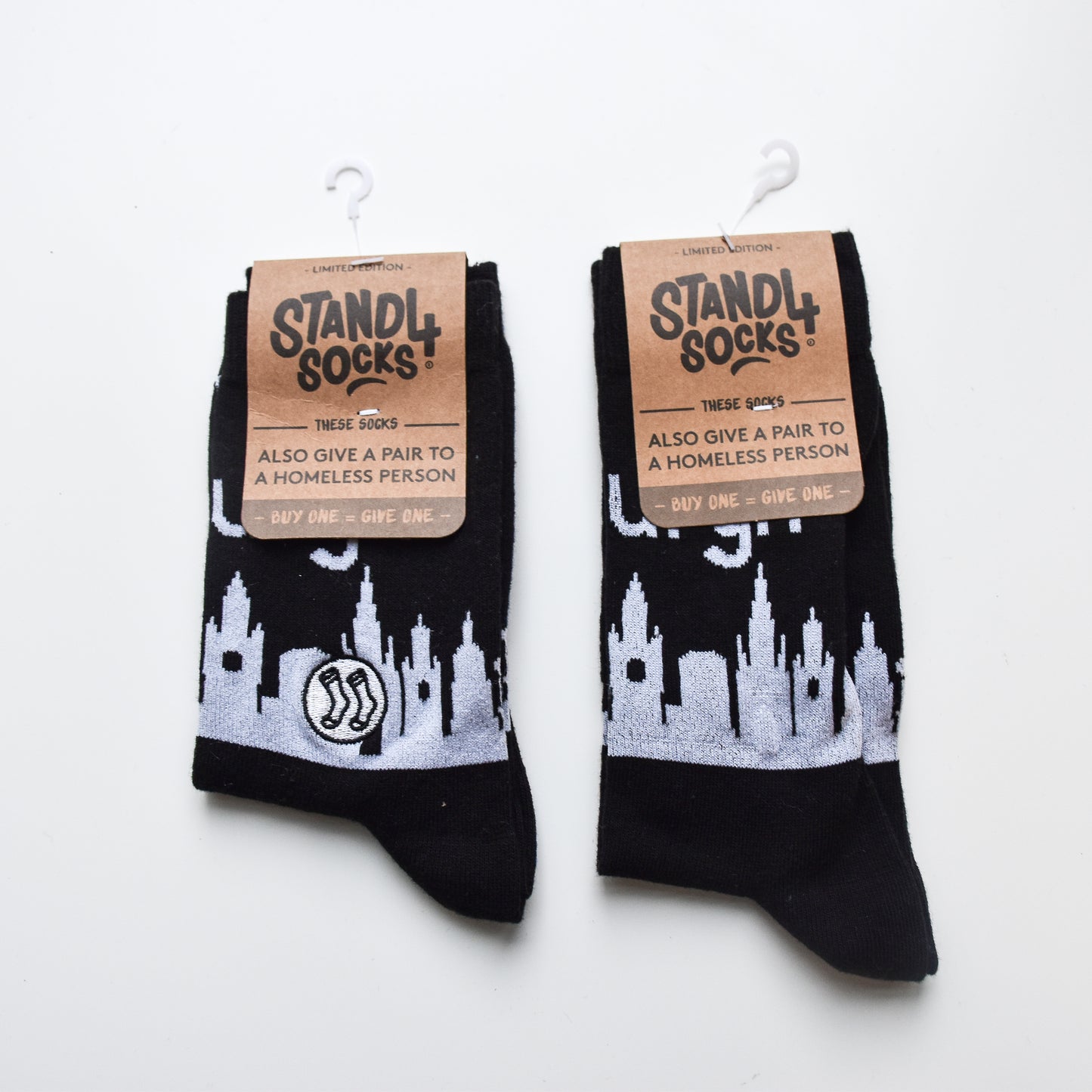 Black skyline socks in Stand4Socks branded packaging. 