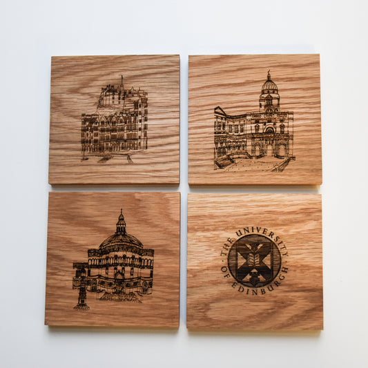 Wooden coasters featuring engravings of Edinburgh University buildings and the University crest.