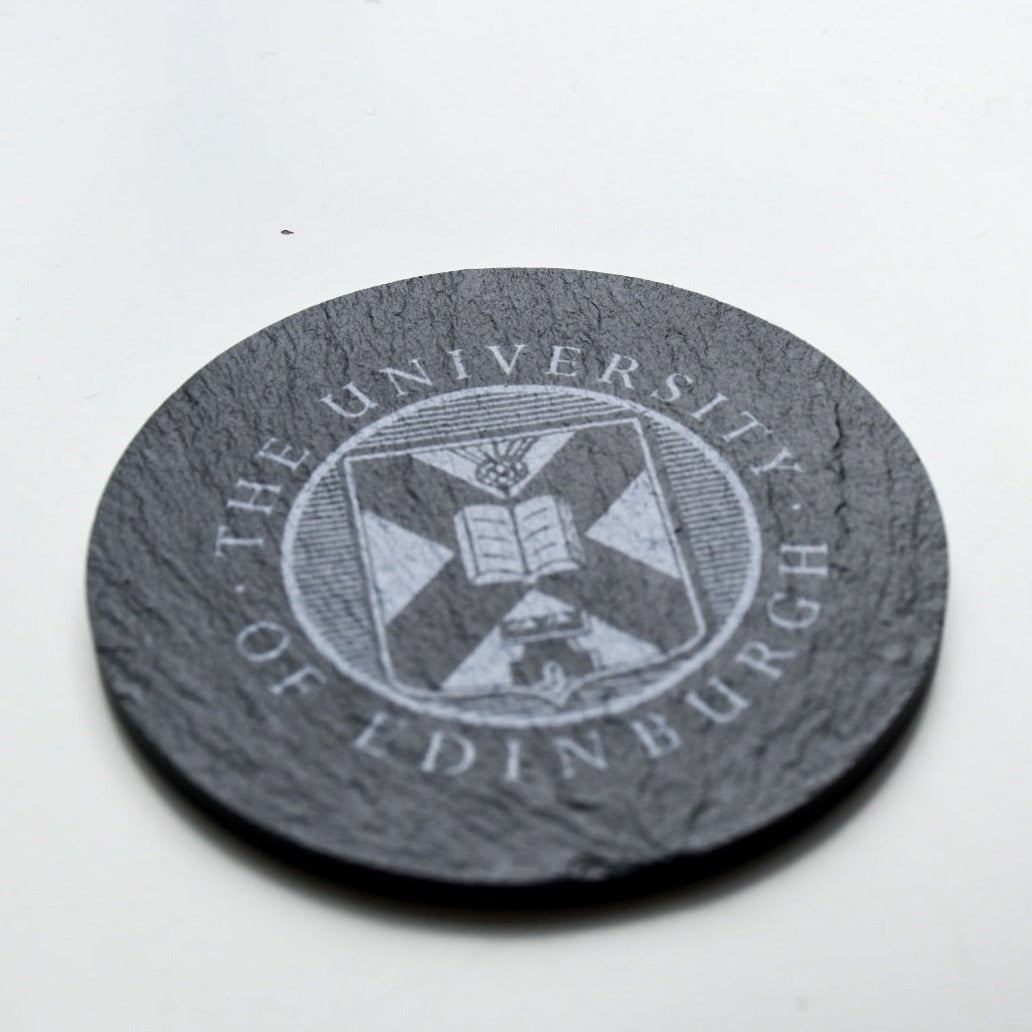 Close up of slate coaster with crest printed