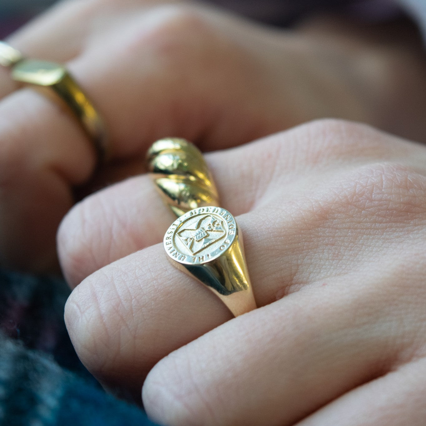 Gold signet ring on a hand