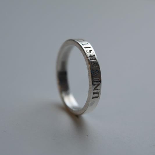 Silver thin band graduation ring showing the text University of Edinburgh