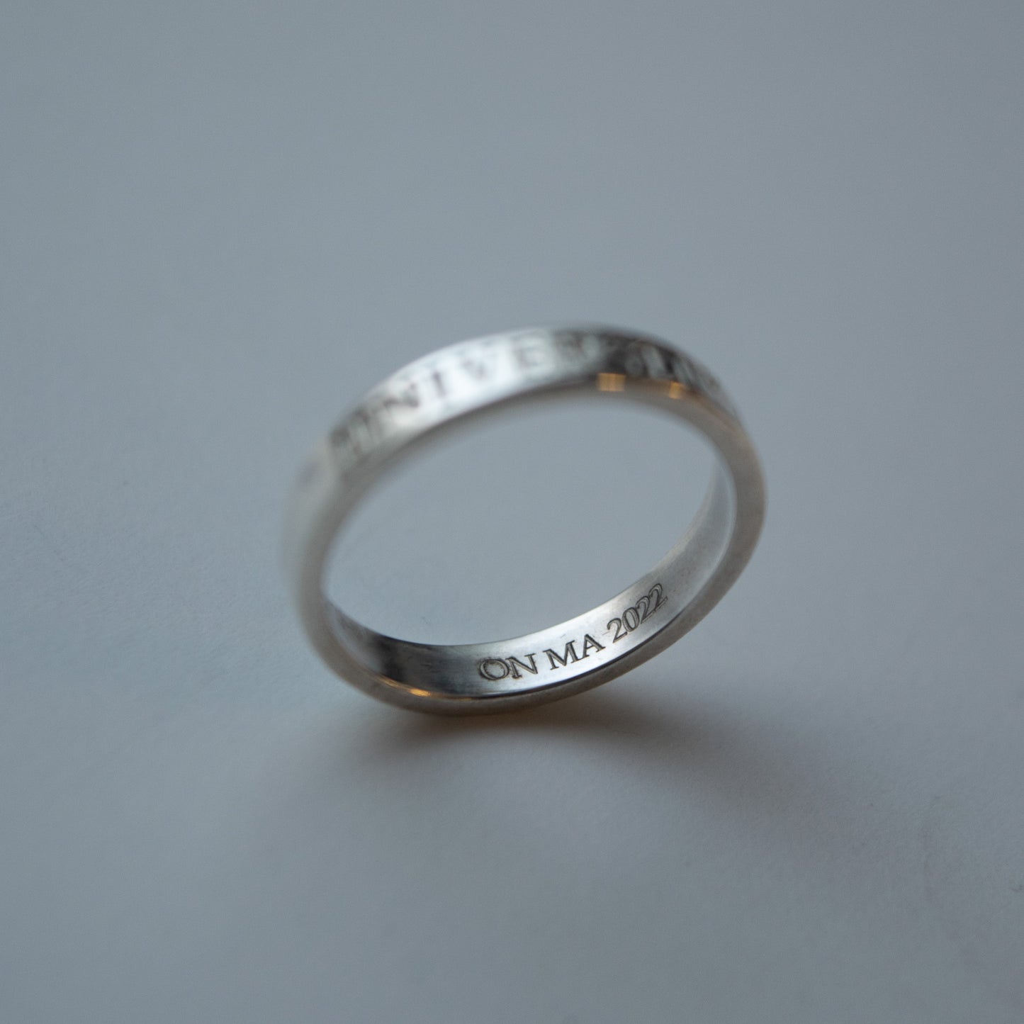 Close up image of the internal personalisation of the thin band silver graduation ring