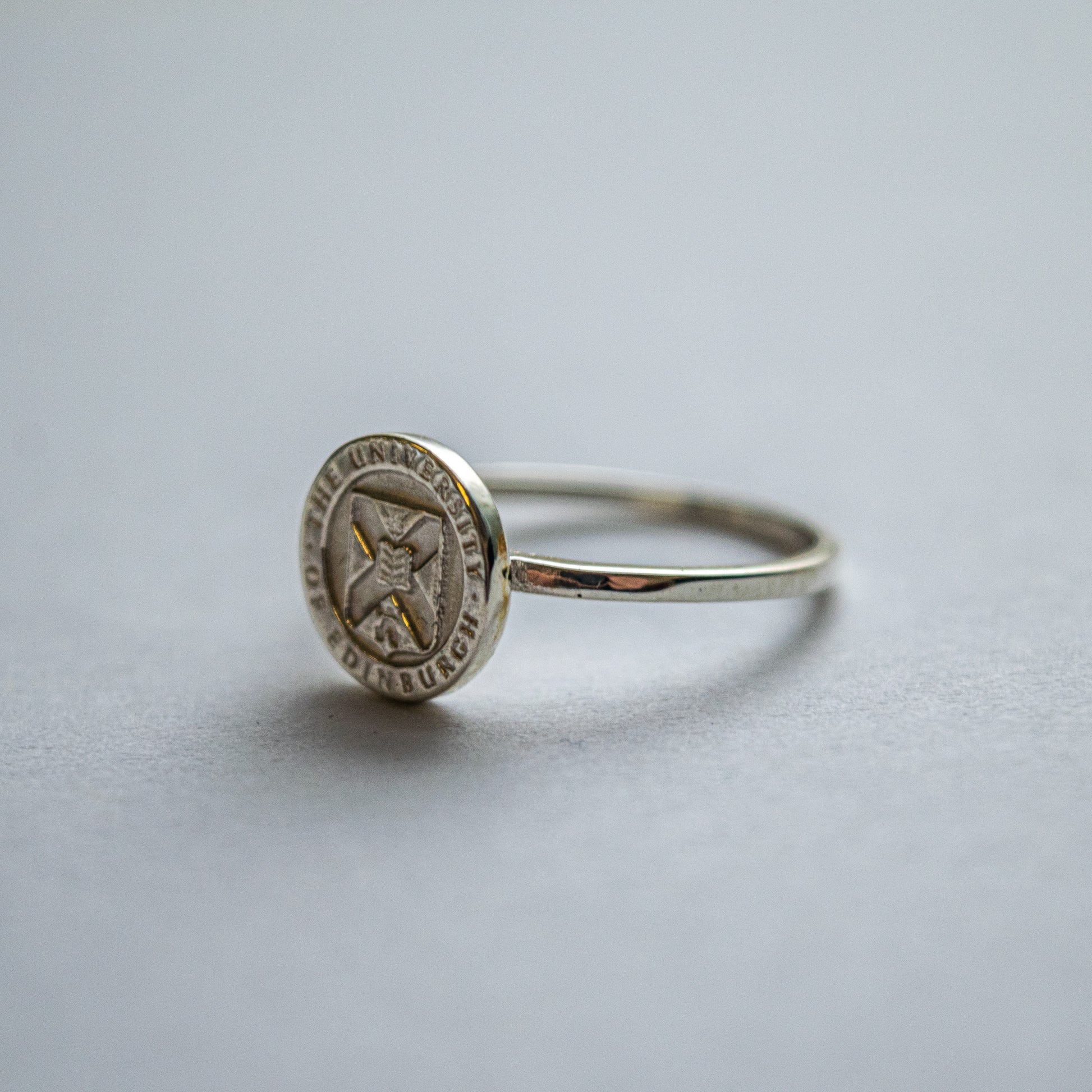 Silver crest on band graduation ring
