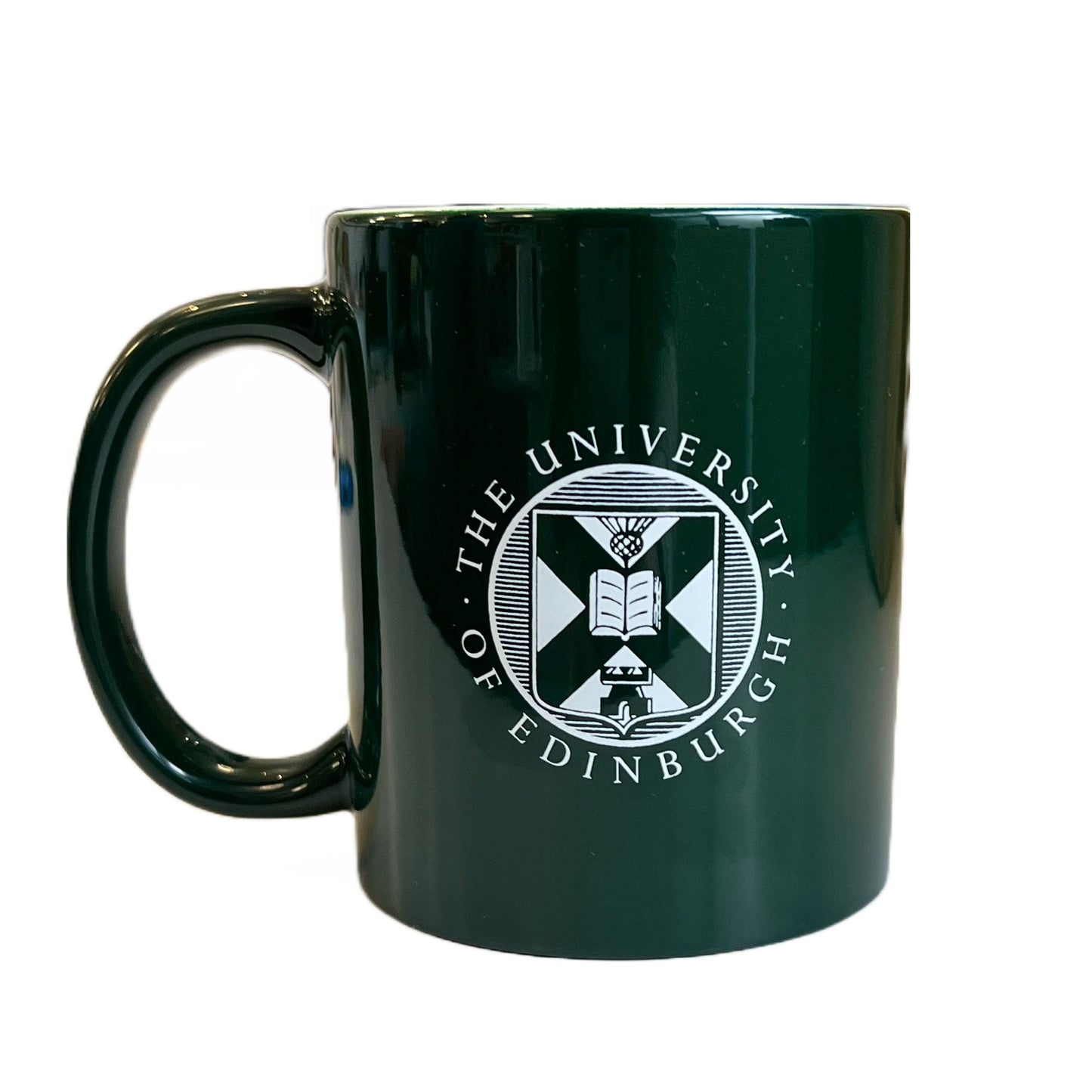 reverse side of green mug with university crest in white