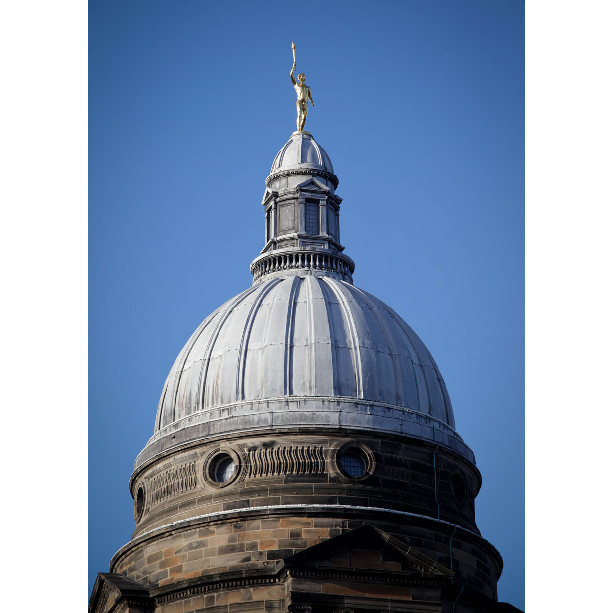 Photograph of Golden boy on top of old college dome