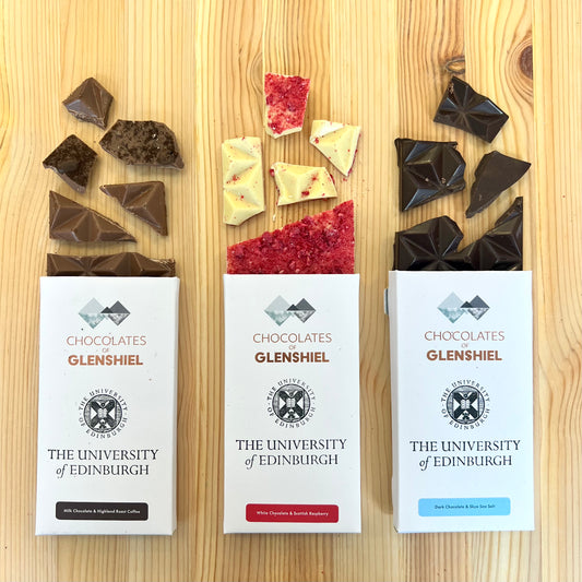 Three different flavored chocolate bars broken into pieces