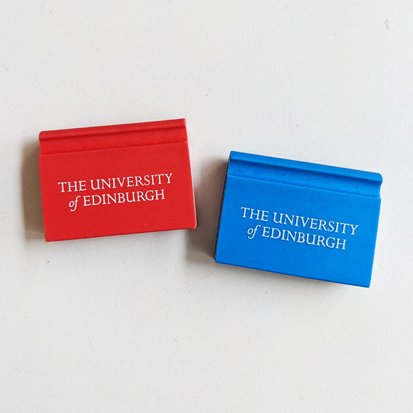Two book shaped erasers, one in red and one in blue, with University branding that reads: 'The University of Edinburgh' in white. 