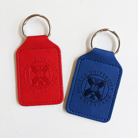 Both the red and blue colourways of our embossed leather keyrings featuring the University crest. 