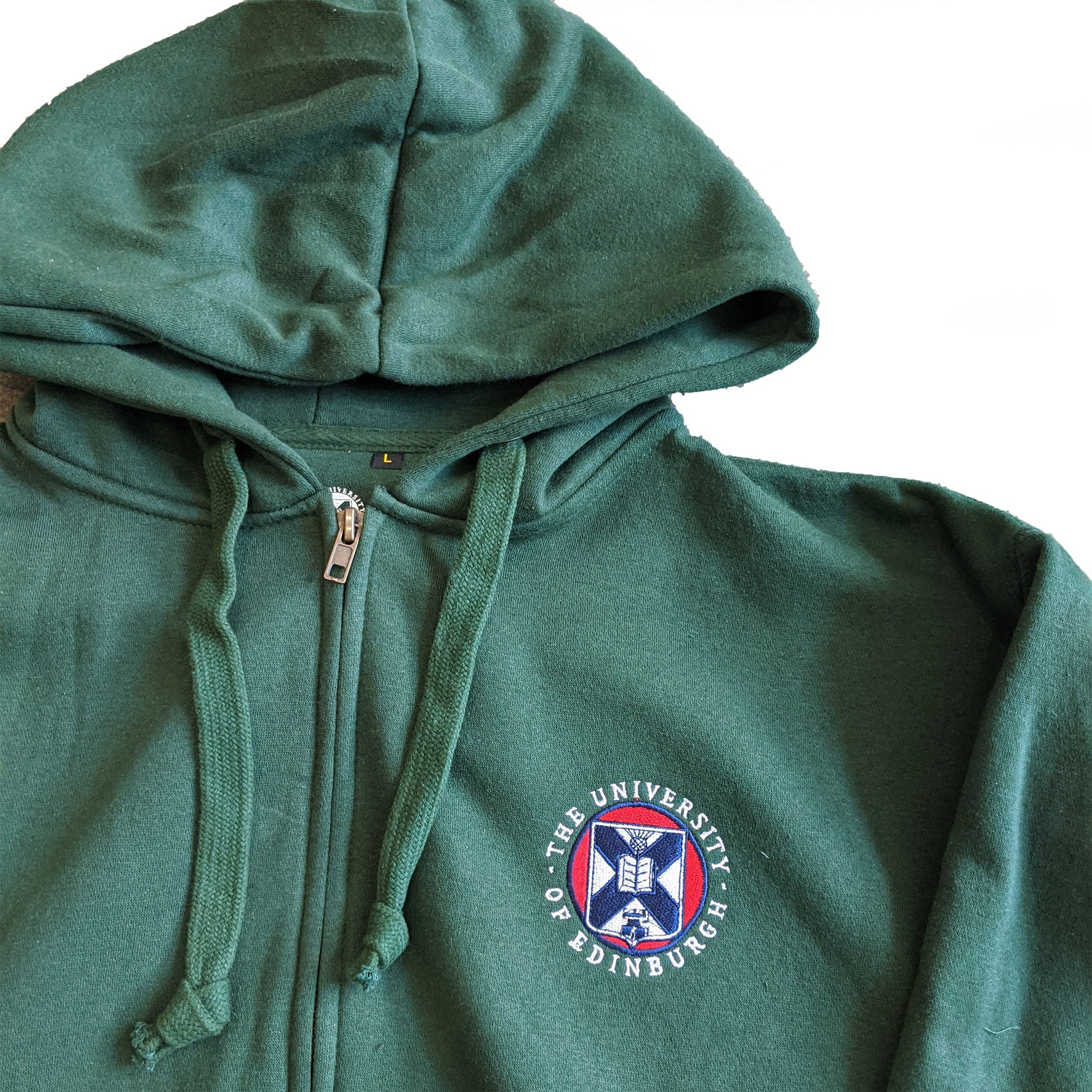 Close up of the embroidered crest on our Classic Embroidered Zipped Hoodie in Green.