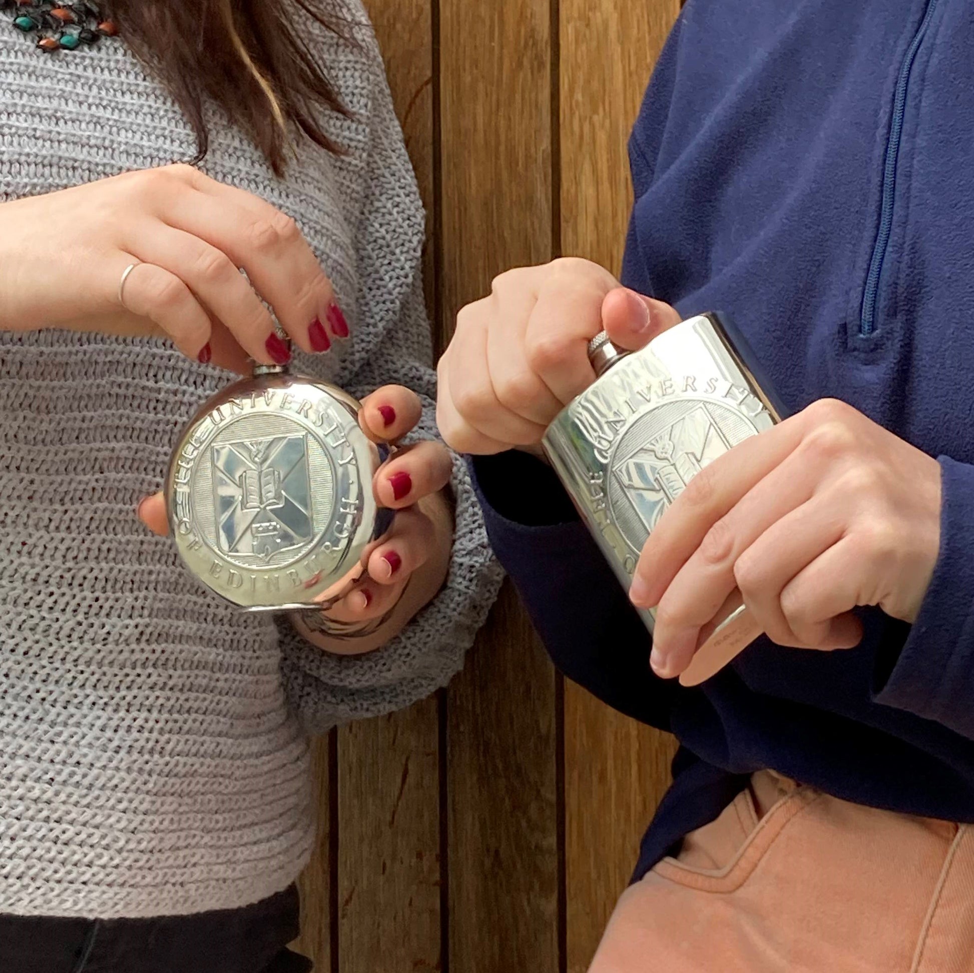 Models holding the Round Pewter Hipflask and the Square Pewter Hipflask. 