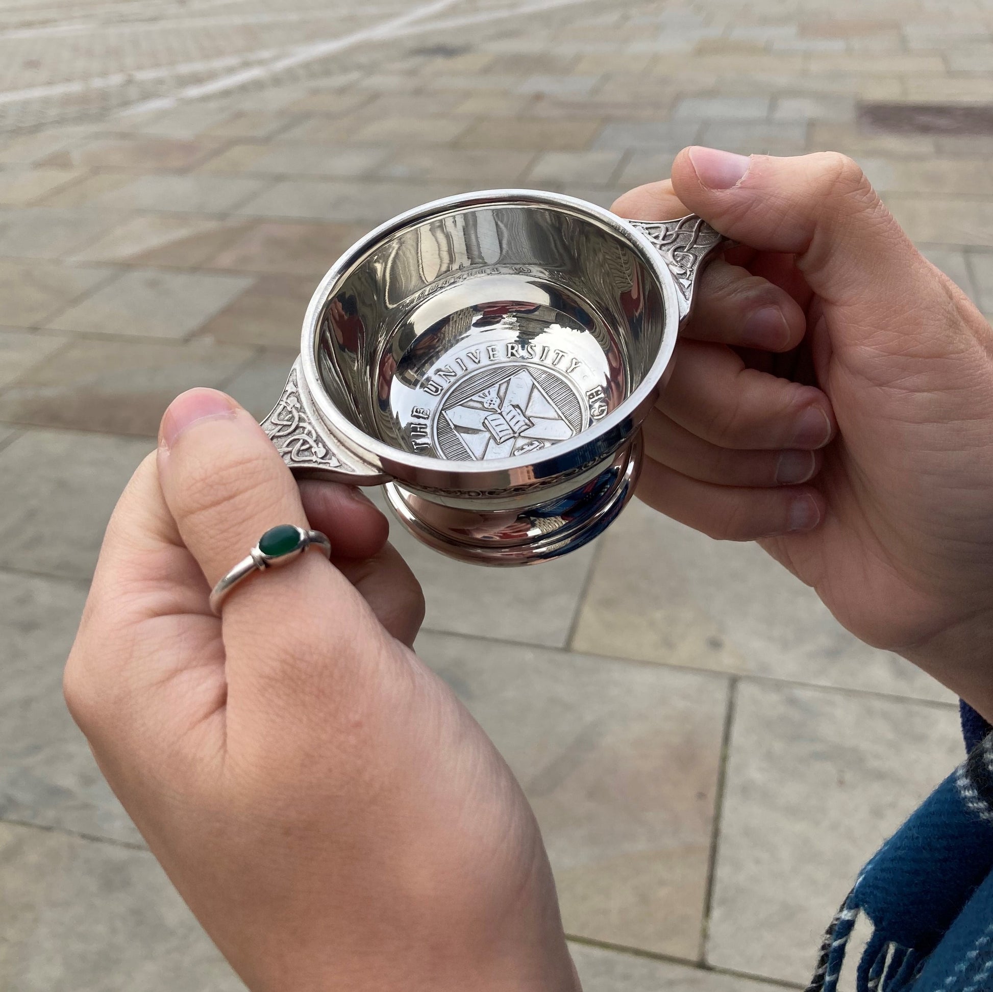 Picture of someone holding the quaich outside. 