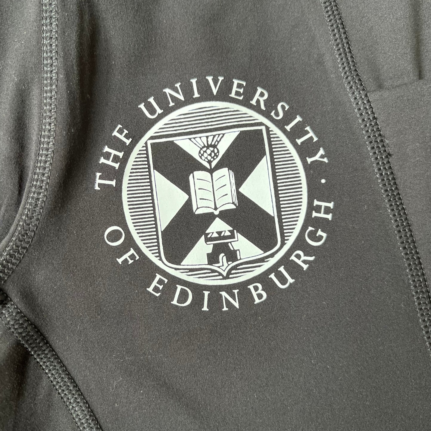 CLose up of the university crest in white