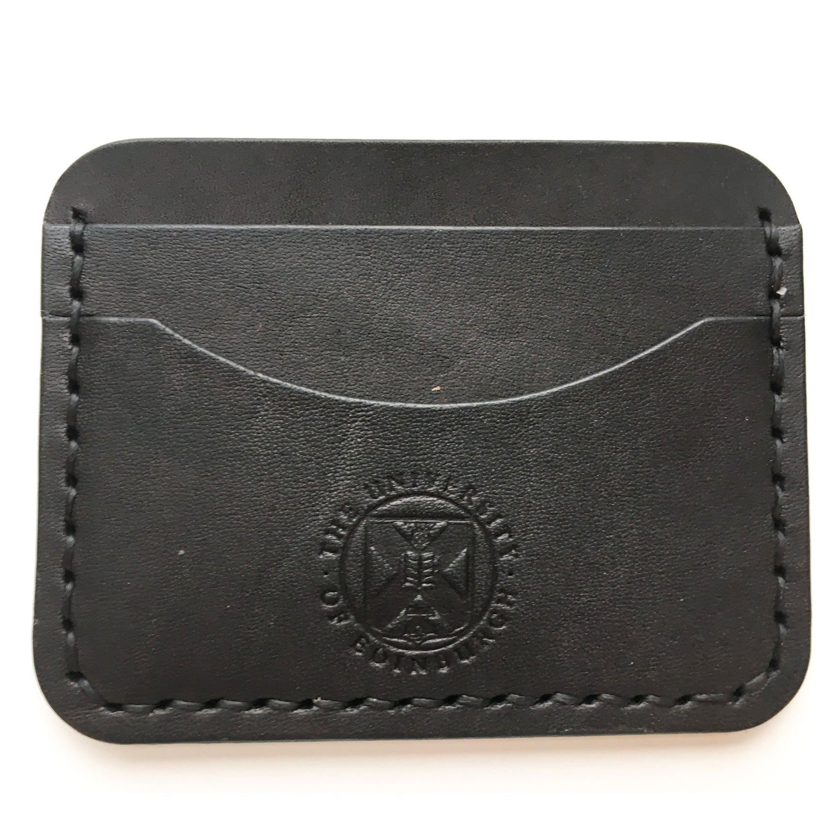 Close up of the black Leather Card Holder demonstrating the stitching detail and the embossed crest. 