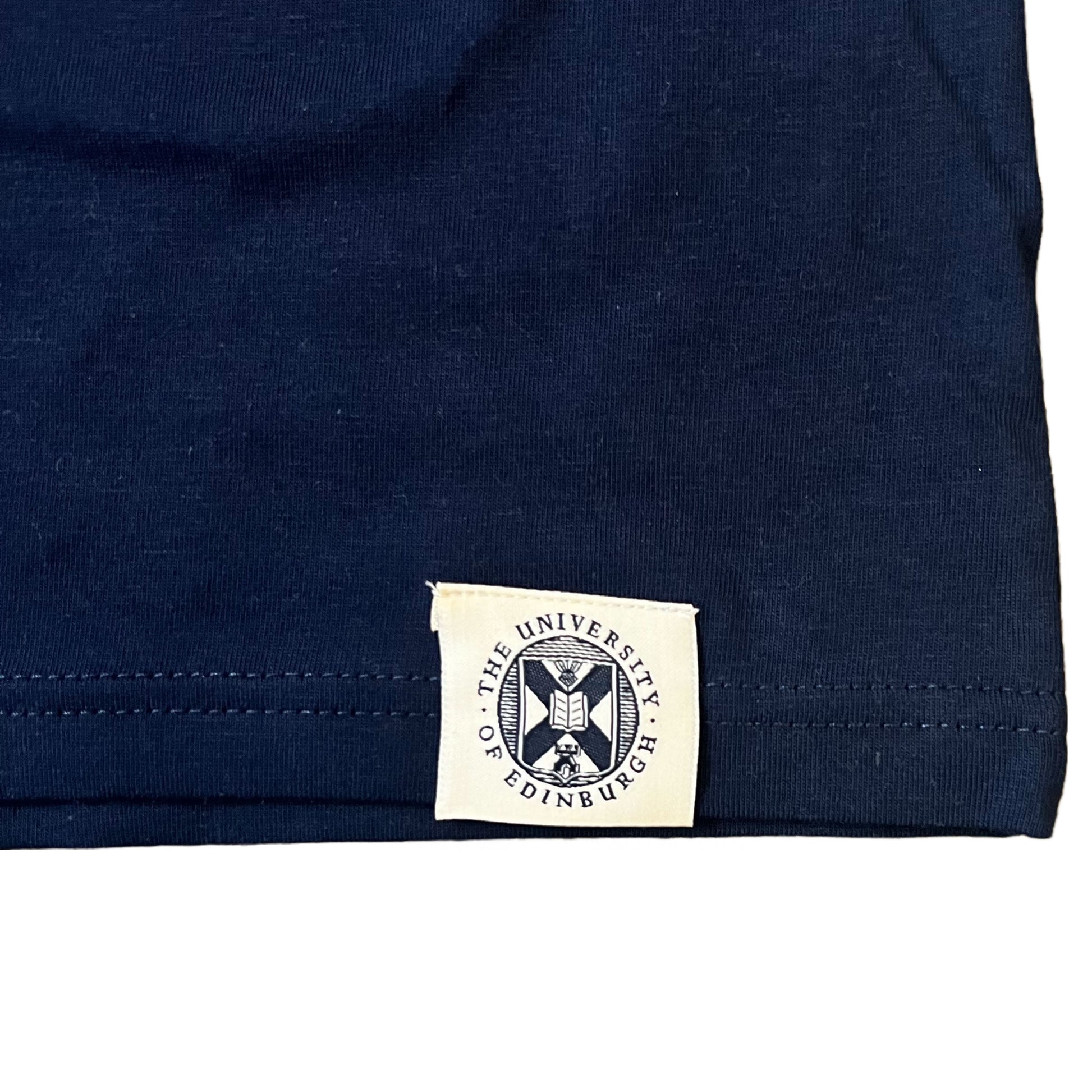 Close up of Navy T-shirt University of Edinburgh crest stitched on the bottom seam