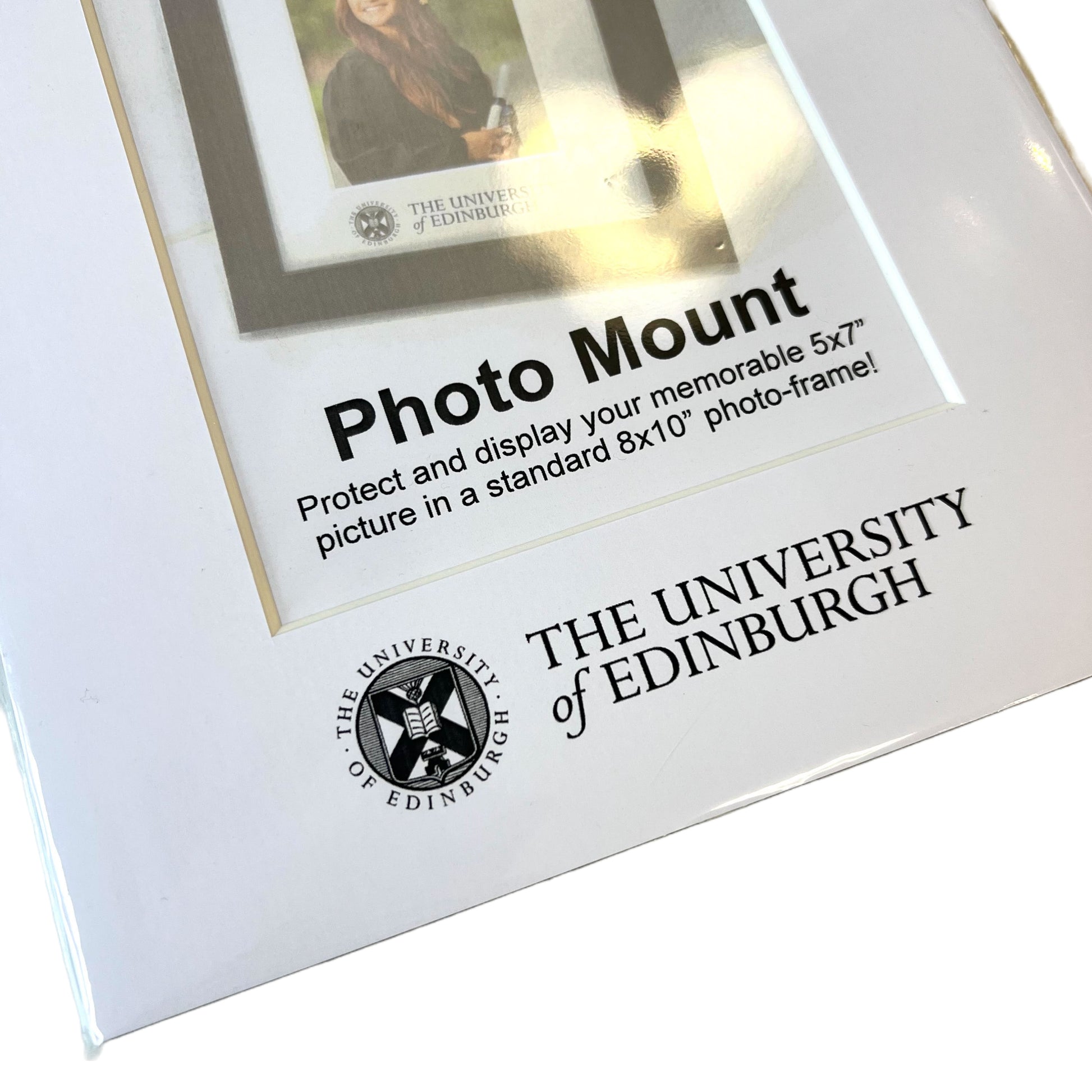 Close up of a white photo mount that focuses on the University of Edinburgh crest symbol at the bottom of the mount
