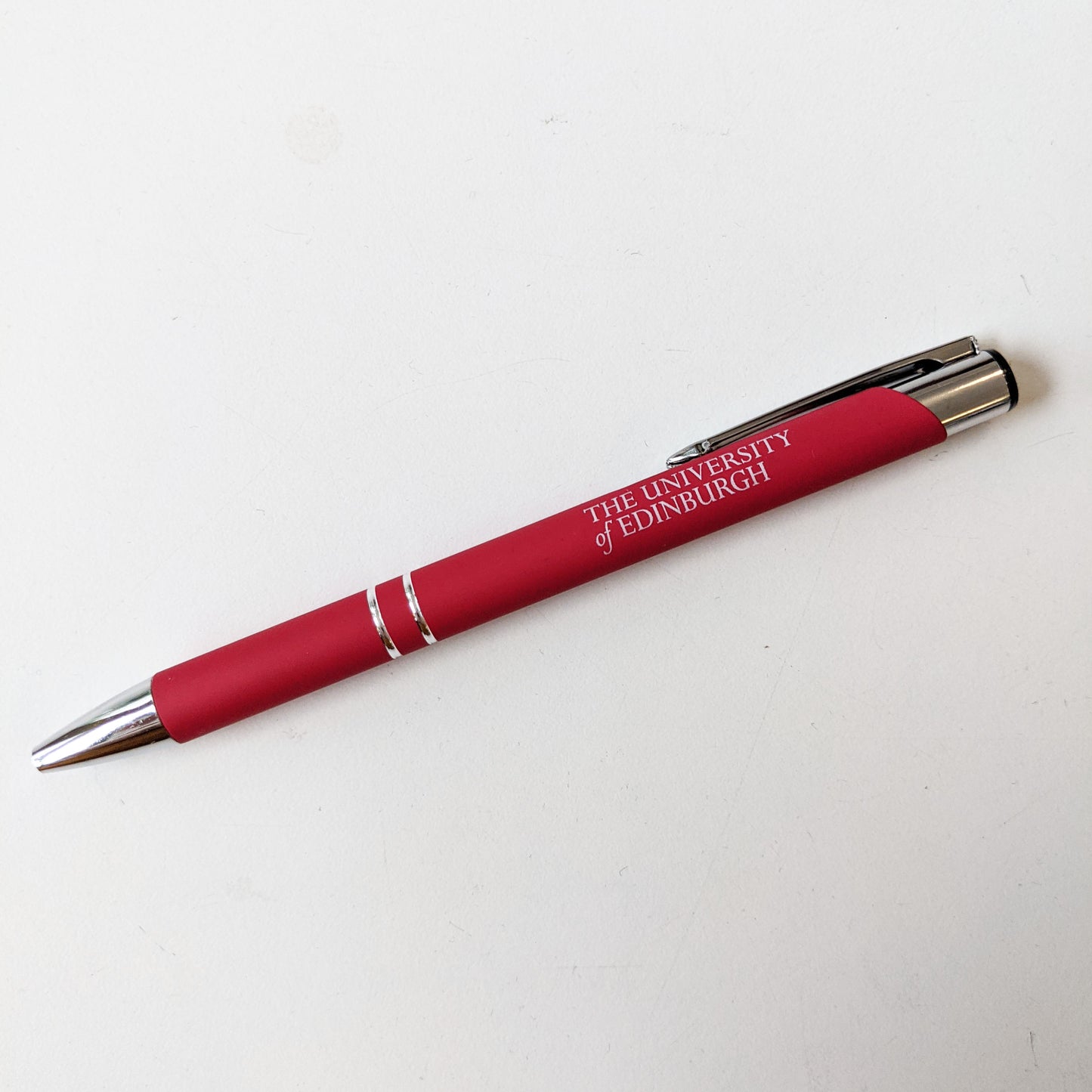 Red soft feel pen with 'The University of Edinburgh' printed on the barrel in white.