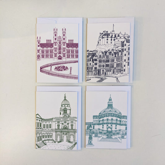 Four greeting cards illustrated by Victoria Rose Ball. From to top left to bottom right: illustrated image of New College with maroon lines; illustrated street view of Edinburgh Castle with navy lines; illustrated image of Old College with dark green lines; illustrated image of McEwan Hall with teal blue lines. Each card is set against its own envelope, and all are set on a white background.