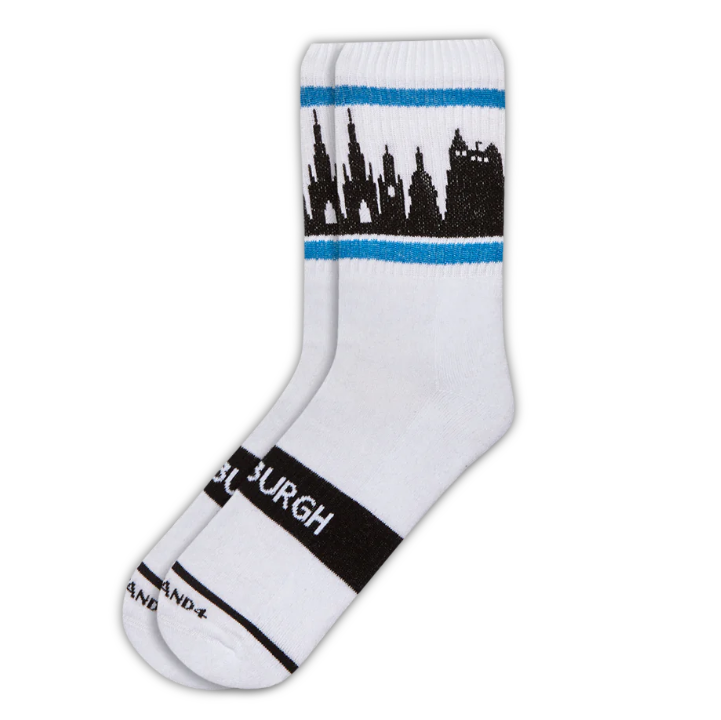 White ribbed crew socks with black silhouette of the Edinburgh skyline, bordered by a blue horizontal stripe.