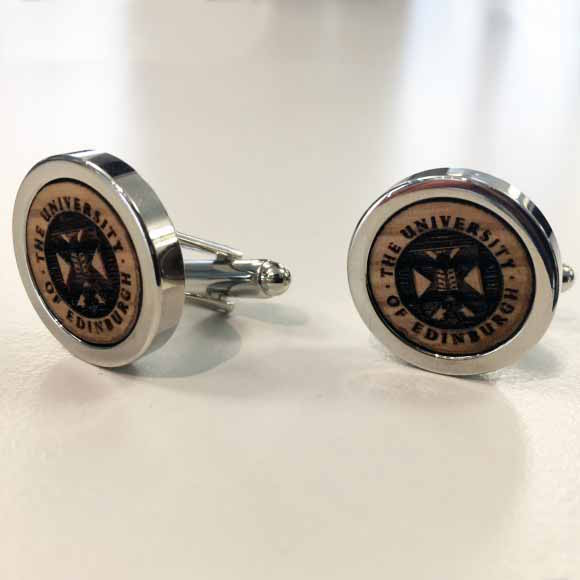 A close up of the laser engraved crest in the centre of the cufflinks 