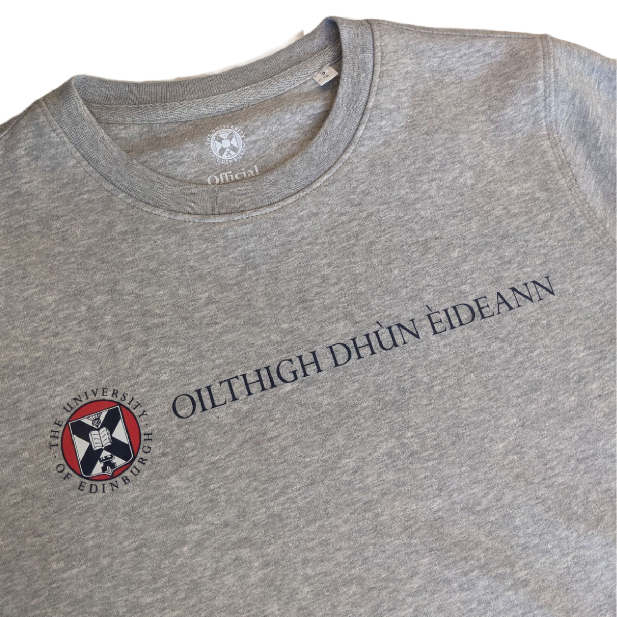 close up of Grey Sweatshirt with the University name in Gaelic in navy print and university crest in navy red and white print
