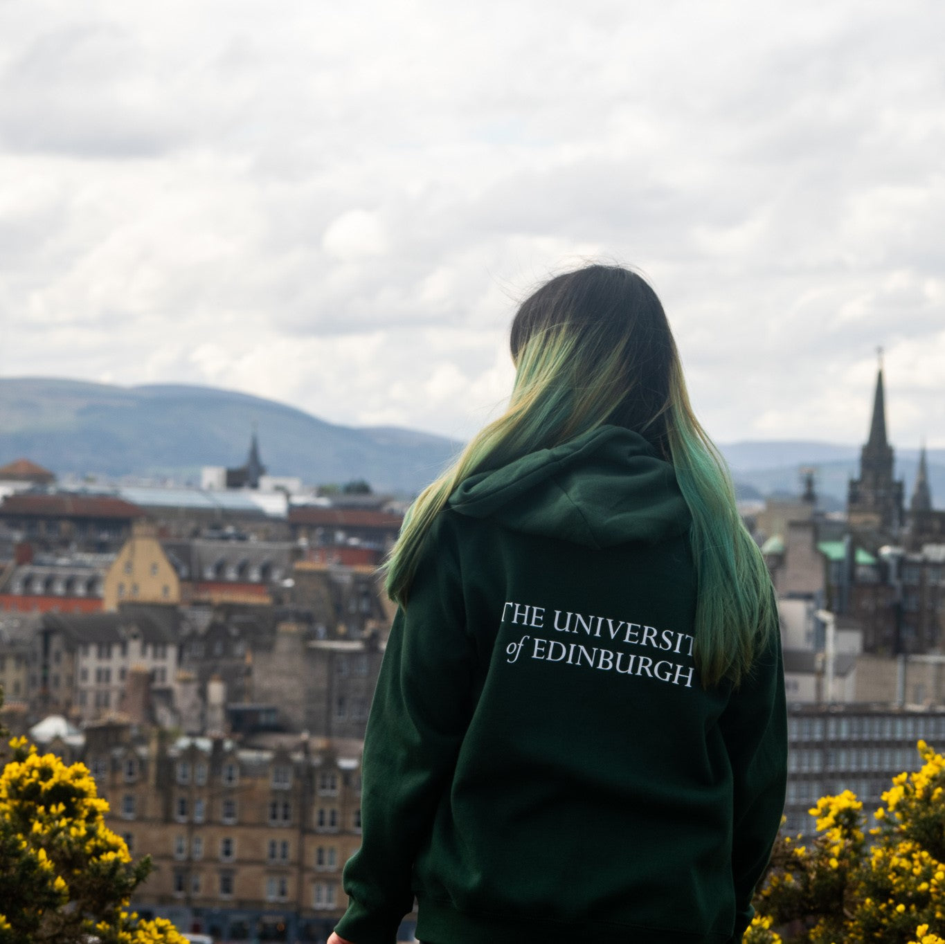 Our Model wears Classic Embroidered Zipped Hoodie in Green, pictured from behind