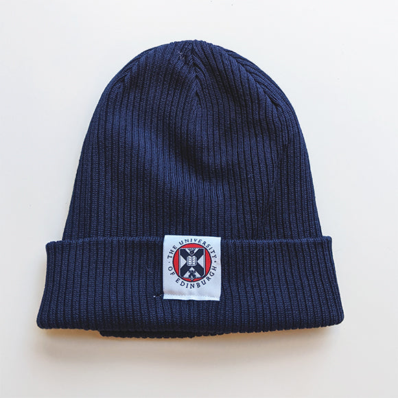 Navy blue beanie with an embroidered label that features the crest on the centre of the brim. 