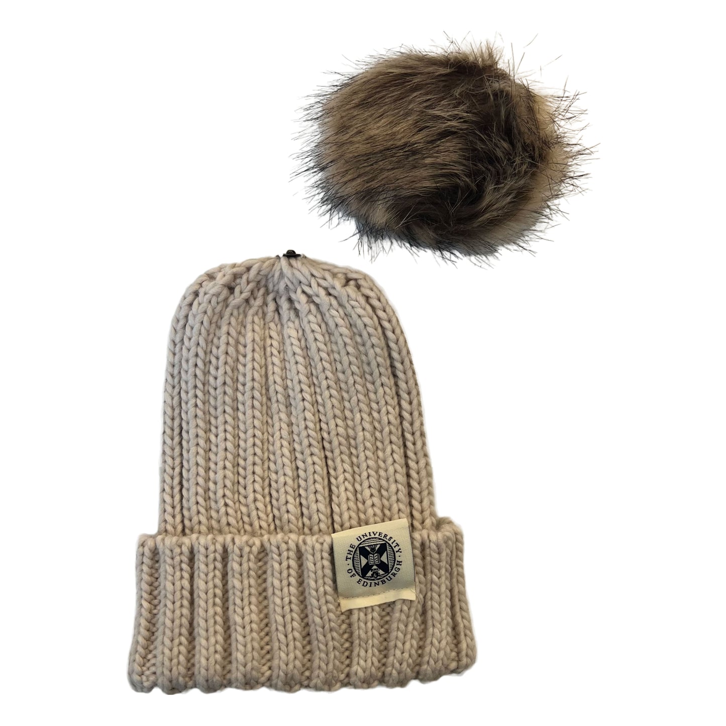 oatmeal beanie with detached brown pom pom and woven tag featuring university crest in navy